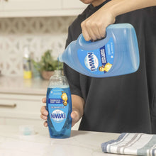 Dawn dishwashing liquid bottles held in hands with blue “50% less scrubbing” labels