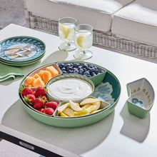 Floral chip and dip tray filled with fruit and dip on a table