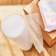 White bubble wrap roll and sheet pieces for packing and shipping protection