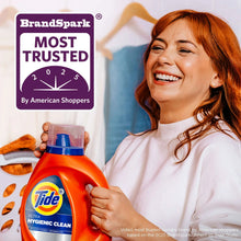 Orange Tide Ultra Hygienic Clean detergent bottle held near a smiling woman in white sweater.