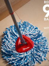 Blue-and-white microfiber mop head with red base on floor