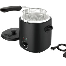 Matte black electric deep fryer with wire basket, lid, and long basket handle