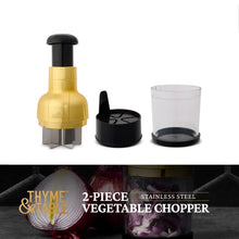 Gold and black veggie chopper with clear cup and black storage container
