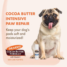Dog paw repair balm swivel stick with white cap held beside a dog