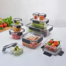 Tritan food storage containers with clear bodies and black snap lids, with food inside