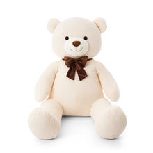 Cream corduroy plush bear with a brown bow tie, seated with legs outstretched