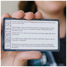 Blue patterned question card held in hands with trivia prompts and icons