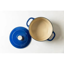 Indigo blue Dutch oven with cream interior and matching lid, open view
