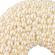 Close-up of white pearl-like beads on a heart wreath