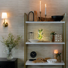 White scalloped decorative tabletop bowl on display shelf
