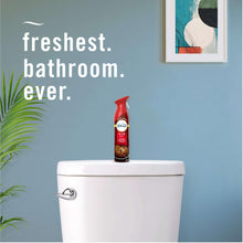 Red aerosol air freshener bottle on toilet tank in a bathroom