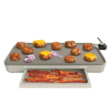 Electric griddle with warming tray, gray top with assorted cooked foods.