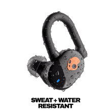 True wireless earbuds with water droplets, black earbuds with orange skull logo on the faceplate.