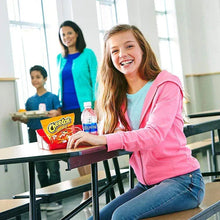 Cheetos snack bag held at school table by a smiling person