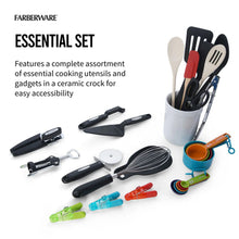 Ceramic crock utensil set with black, wood, and colorful cooking tools and whisk