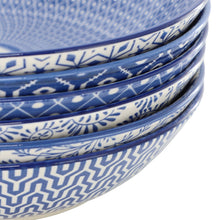 Stacked blue-and-white porcelain bowls with geometric border pattern, close-up