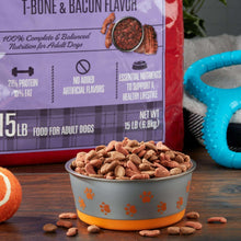 Dog food kibble in bowl beside T-bone & bacon flavored dry food bag