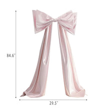 Pink satin decorative bow with two long ribbon streamers, center knot