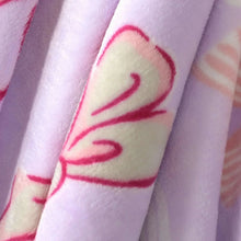 Lavender plush blanket detail with red heart outline and ribbon icon