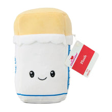 Butter plush with smiling face; white body, pale yellow cap, attached red tag