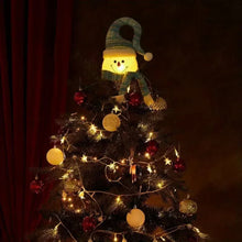 Lit plush snowman Christmas tree topper on a decorated Christmas tree
