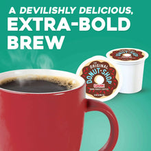 Dark roast coffee pods with K-Cup lid and cup of brewed coffee