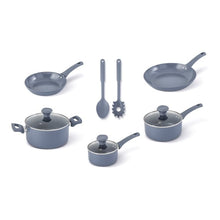 Blue ceramic non-stick cookware set laid out: skillets, saucepans, and tools