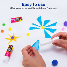 White glue stick applying glue to paper craft flower shapes
