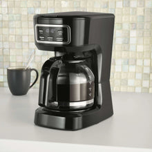 Black programmable drip coffee maker with open filter area and glass carafe