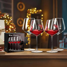 Two red wine glasses with burgundy wine, clear ribbed goblets on wooden surface