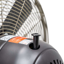 Black fan control housing with buttons on vintage metal stand fan