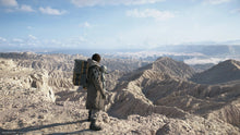 PS5 video game scene: soldier with cargo pack overlooking a rocky mountain landscape