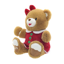 Brown teddy bear plush with red bow, red dress with green buttons and white trim, side view