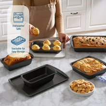 Gray non-stick bakeware pans with baked items on countertop, including loaf and muffins