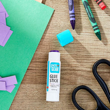 Pen+Gear purple disappearing glue stick with teal cap on craft surface