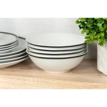 Stack of ceramic bowls with black rim bands