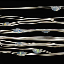 Multicolor LED wire lights with small clear bulbs on silver wire, close-up