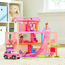 Pink dollhouse playset with slide, furniture, and vehicles for dolls