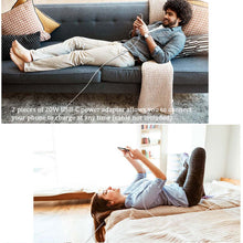 White wall USB charger with connected charging cable in a home living room
