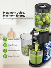 Black quiet slow masticating juicer with green juice in a glass jar beside it.
