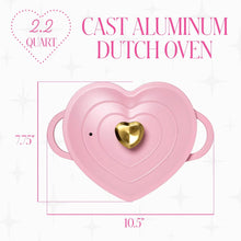 Heart-shaped Dutch oven with pink body, gold heart knob lid, and loop handles