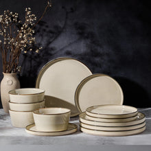 Cream ceramic plates and bowls with thin gold rim, reactive-glaze finish