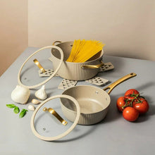 Taupe ceramic nonstick cookware set with ribbed pots and pans, gold handles, lids