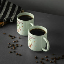 Light green ceramic mug set showing baby frog in boots with dark coffee inside