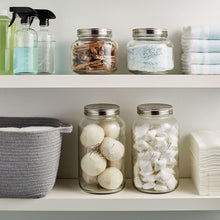 Ball mason jars with stainless lids, clear glass filled with white pantry items and solids