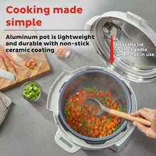 Open pressure cooker with inner pot, vegetable pieces, and wooden utensil
