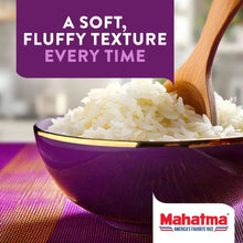 Bowl of jasmine rice with wooden spoon