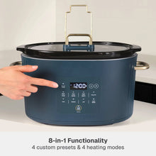 6QT programmable slow cooker in slate blue with hand on lid handle and control panel