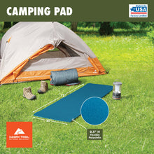 Blue closed-cell foam sleeping pad laid flat near a camping tent setup