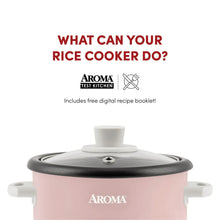 Pink rice cooker with black lid, side handles, and front cook/warm switch panel